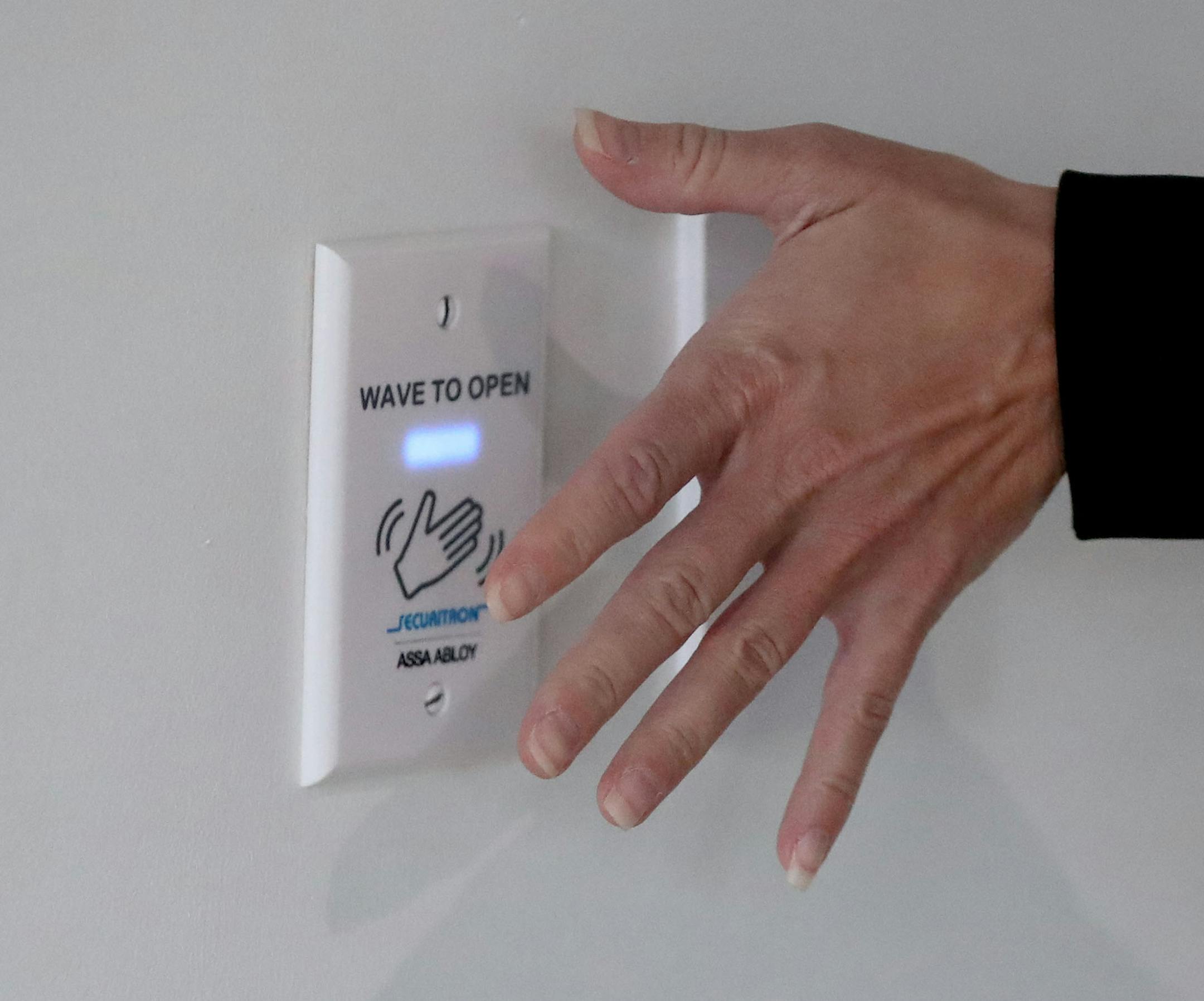 A hand waved next to a sensor is all that is needed to activate a touchless door opener at Delta Dental Minnesota's corporate offices Thursday in Minneapolis.Thursday in Minneapolis. ] DAVID JOLES • david.joles@startribune.com Thursday, Oct. 1, 2020, in Minneapolis, MN Standalone feature photo