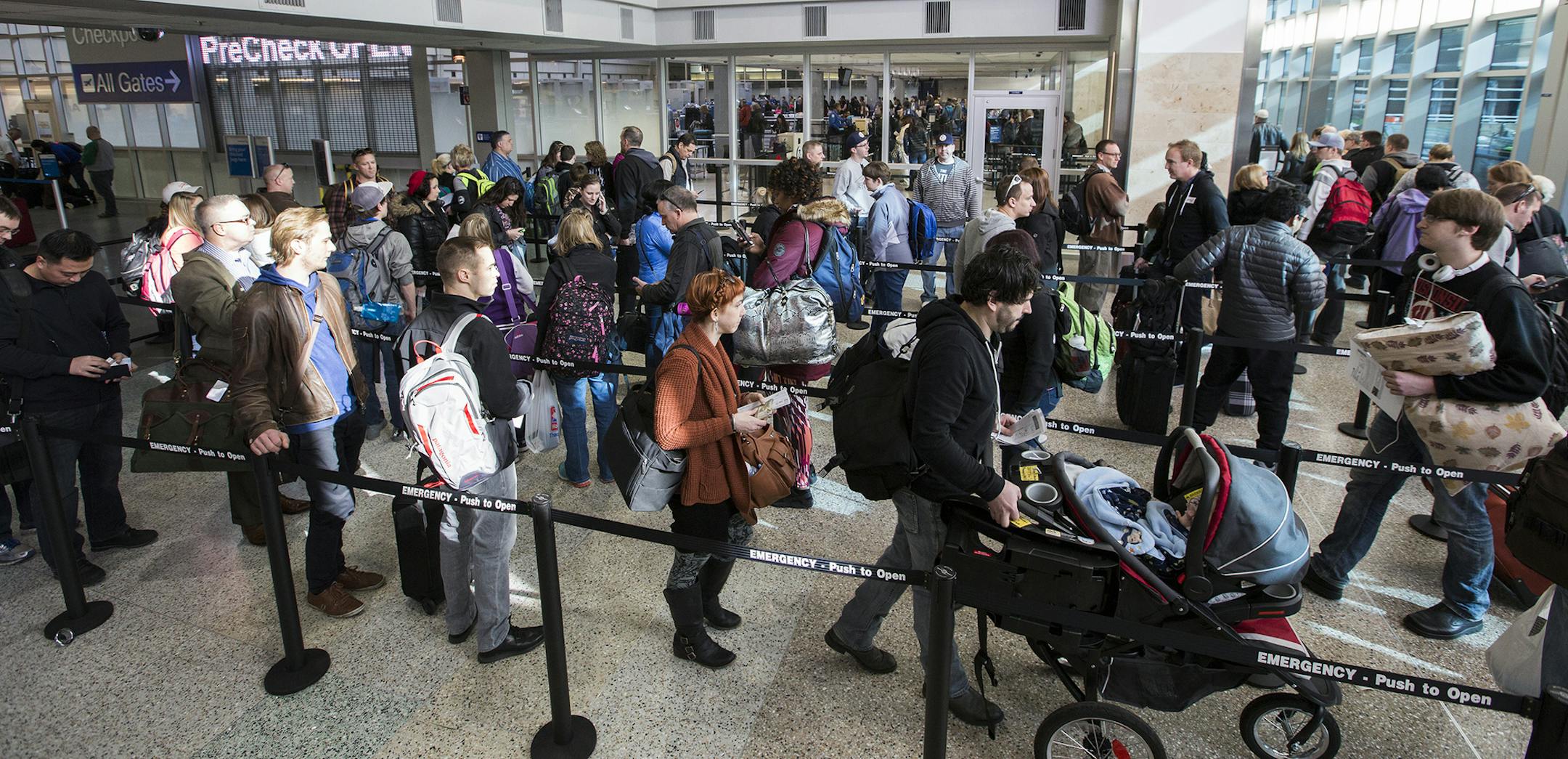 Passengers wait in line to go through the new north security checkpoint at Terminal 1 of Minneapolis-St. Paul International Airport. ] (Leila Navidi/Star Tribune) leila.navidi@startribune.com BACKGROUND INFORMATION: Friday, February 26, 2016 at Terminal 1 of Minneapolis-St. Paul International Airport. ORG XMIT: MIN1602261047171403