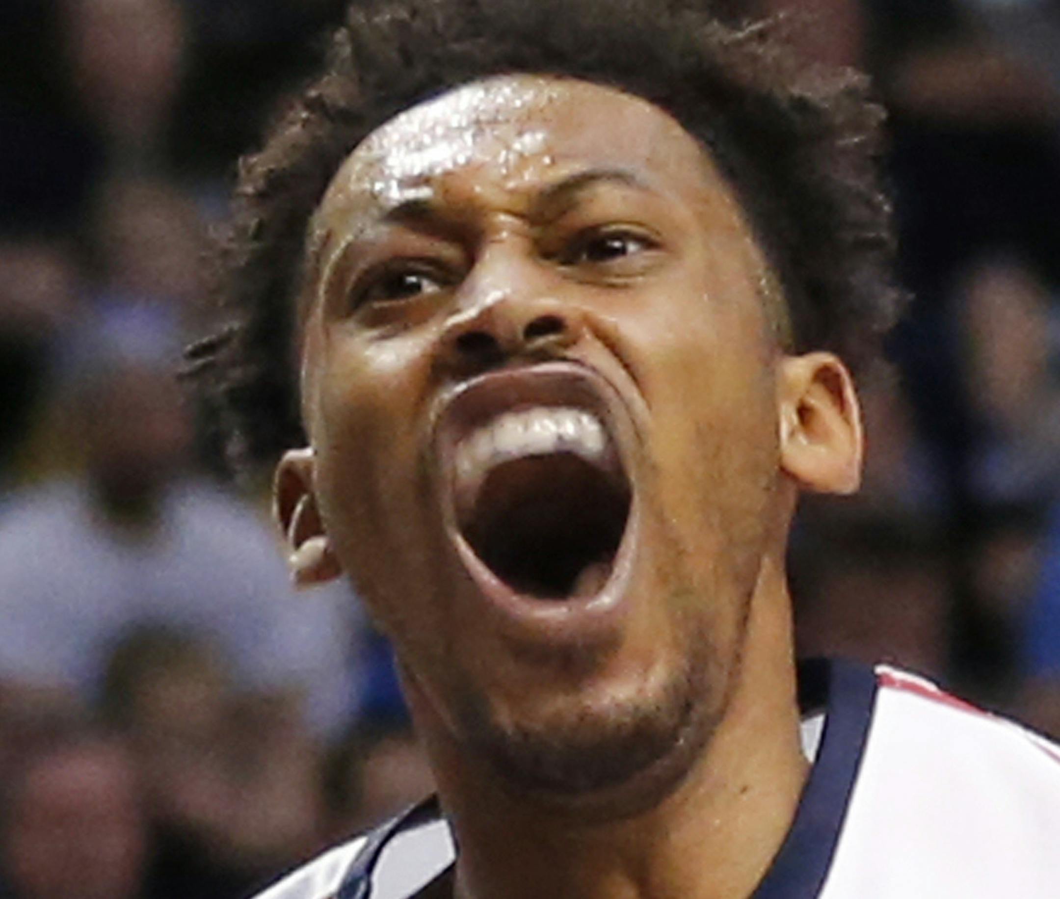 Gonzaga forward Johnathan Williams, right, reacts after dunking while BYU forward Yoeli Childs (23) watches during the first half of an NCAA college basketball game Saturday, Feb. 24, 2018, in Provo, Utah. (AP Photo/Rick Bowmer) ORG XMIT: UTRB112
