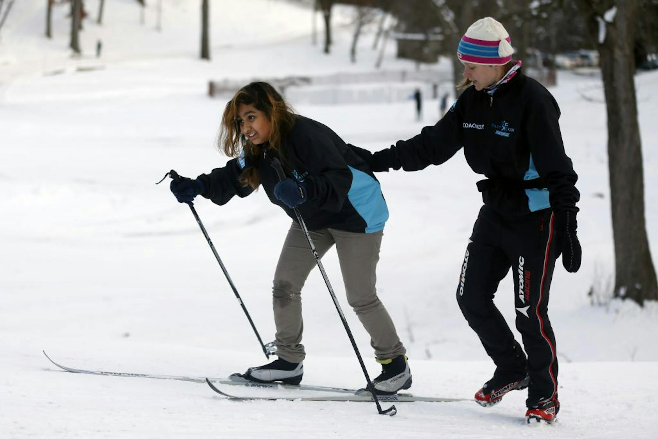 Yoana Rojas got a boost from coach Audrey Weber at a sponsored outing at Theodore Wirth Park.