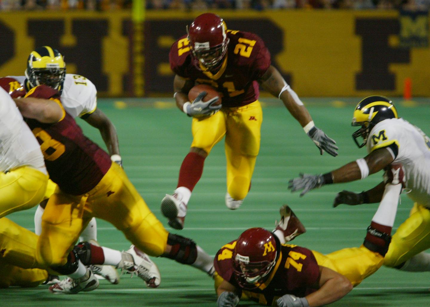 Marion Barber jumps through a hole on his way to score the first Gophers TD against Michigan on Oct. 10, 2003.