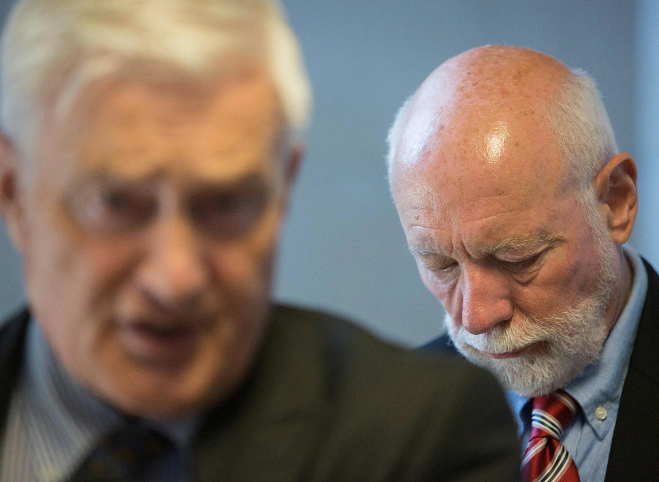 Former Shattuck-St. Mary's teacher Lynn Seibel, right, waits as his attorney James Martin speaks to reporters at the Rice County Courthouse Friday, July 12, 2013 in Fairbault, Minn. Seibel, a former Shattuck-St. Mary's teacher pleaded guilty Friday to sexually abusing six students at the Faribault boarding school more than a decade ago. (AP Photo/Minnesota Public Radio, Jennifer Simonson)