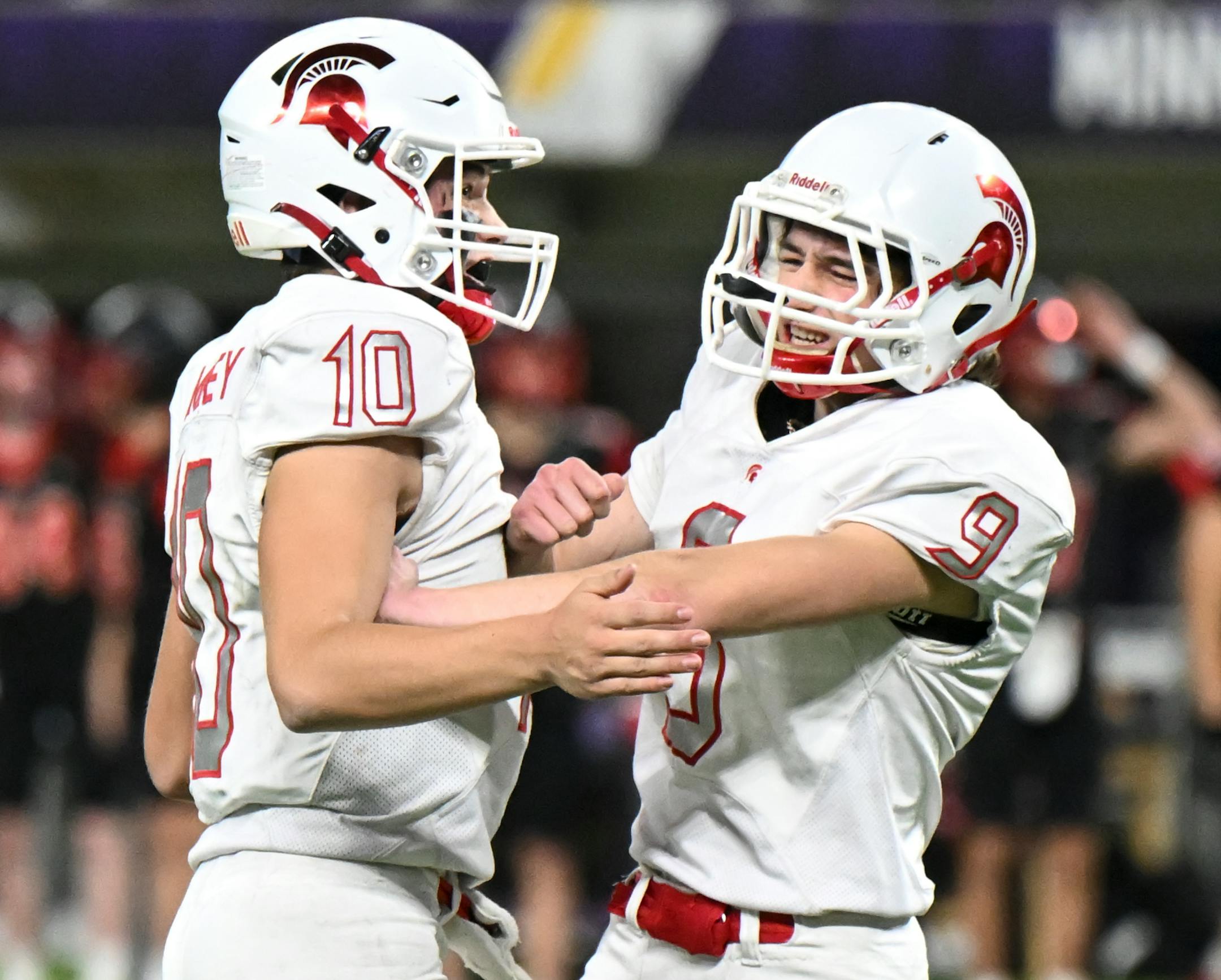 Simley kicker Reid Remackel (9) celebrates with quarterback Caden Renslow (10) after kicking what would be the game-winning field goal during the fourth quarter.