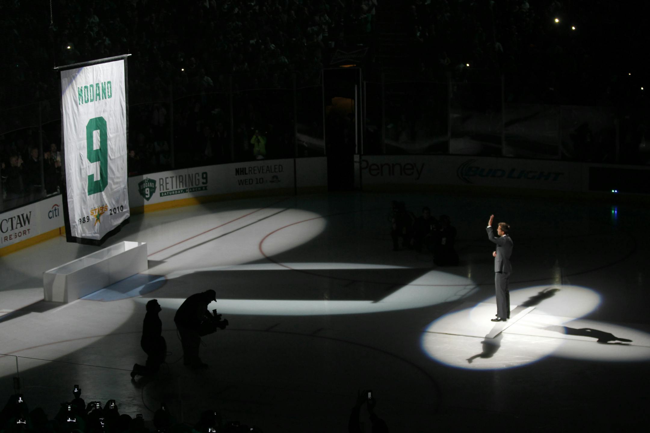 Former Dallas Star Mike Modano watches as his jersey number is raised as the number was retired, before the NHL hockey game between the Stars and the Minnesota Wild on Saturday, March 8, 2014, in Dallas. (AP Photo/The Dallas Morning News, Nathan Hunsinger) MANDATORY CREDIT; MAGS OUT; TV OUT; INTERNET USE BY AP MEMBERS ONLY; NO SALES