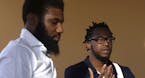 In this Wednesday, April 18, 2018 photo, Rashon Nelson, left, listens as and Donte Robinson, right, addresses a reporter's question during an intervie