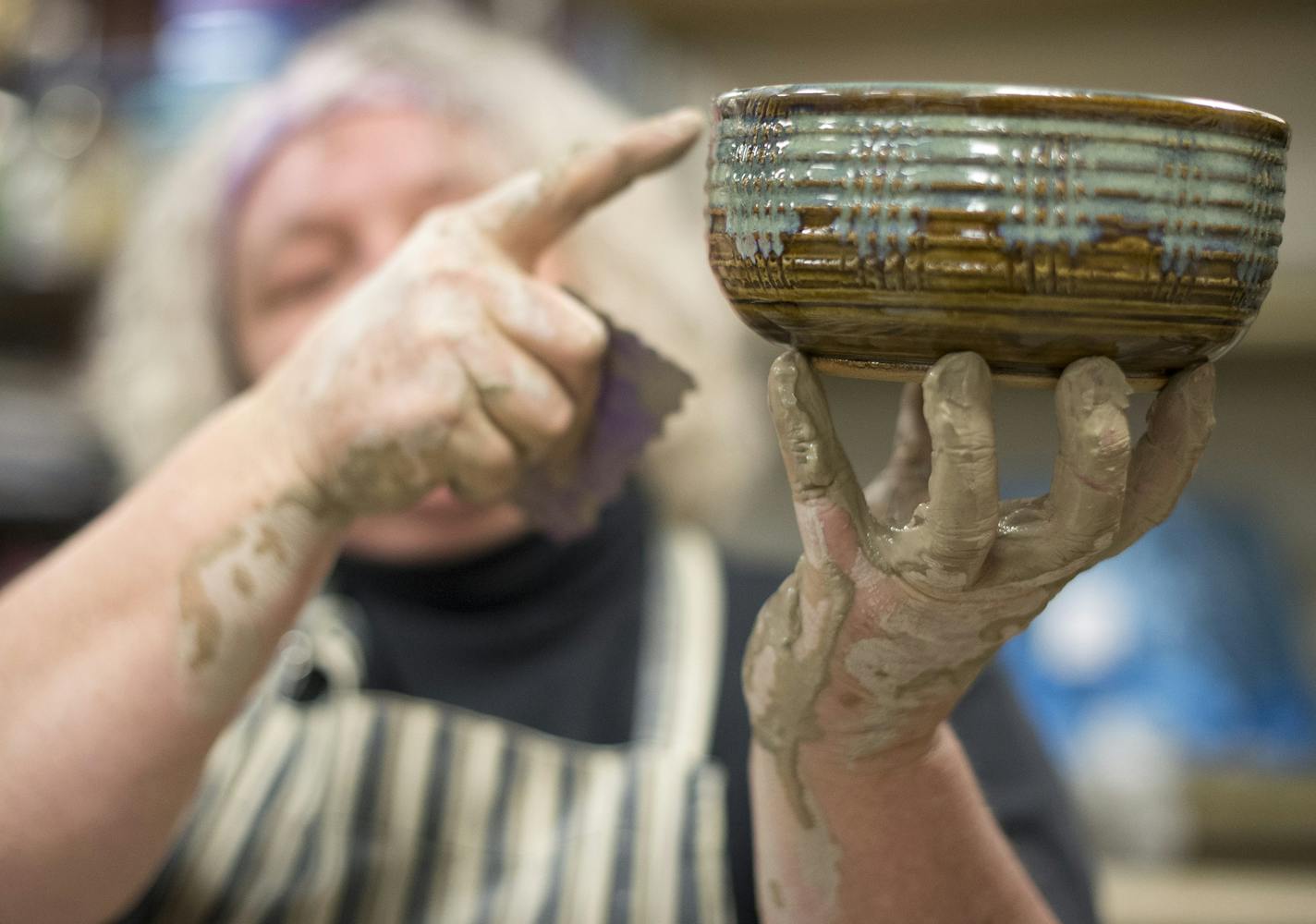 Pottery instructor JoAnne Andres shows one of her finished products, a bowl detailed with tools called a "textured rib" and a "steve," both used during Thursday night's class as part of her presentation. ] (Aaron Lavinsky | StarTribune) Students at the Lakeville Area Arts Center take a pottery class under the tutelage of instructor JoAnne Andres on Friday, Jan. 9, 2015. The course is six weeks long and provides instruction and hands-on demonstration to students hoping to learn how to hand form a