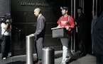 FILE- In this Sept. 15, 2008, file photo a man leaves the Lehman Brothers headquarters carrying a box in New York. Lehman Brothers, a 158-year-old inv