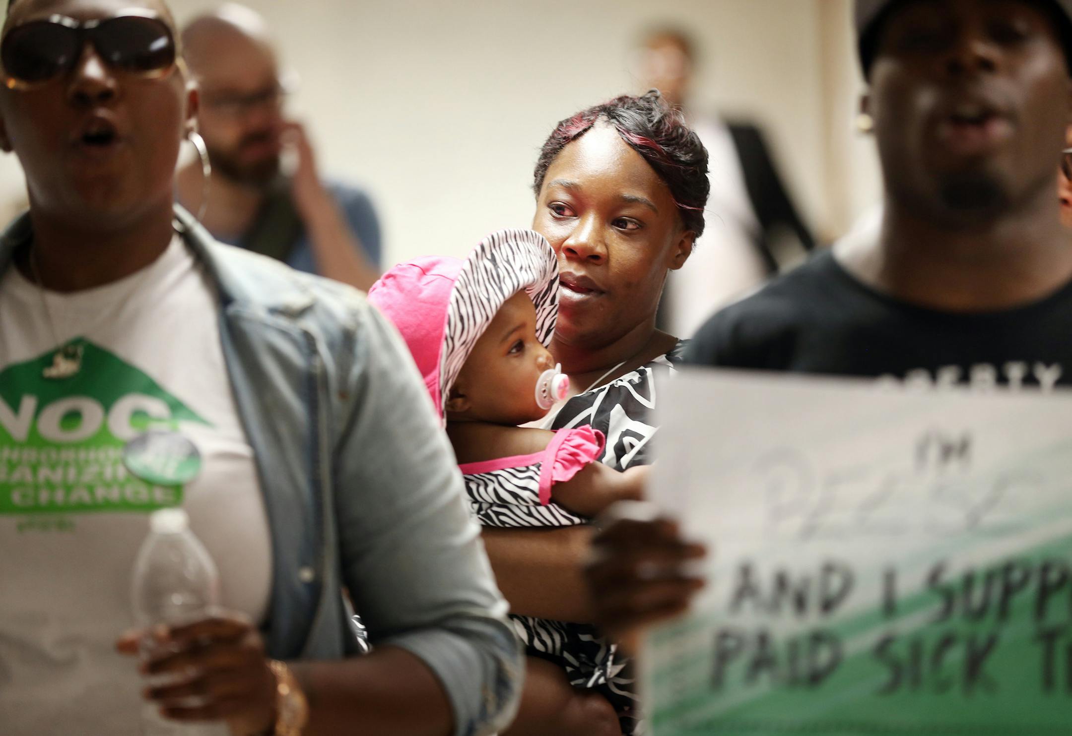 Devona Credit held her daughter Shyrya Credit 2, outside of the Minneapolis city council chambers Wednesday 18, 2016 in Minneapolis, MN.] Devona is a member of Neighborhoods organizing for change and the supports the sick-leave ordinance. Minneapolis City Council held a final public hearing on the proposed sick-leave ordinance at City Hall. Jerry Holt /Jerry.Holt@Startribune.com