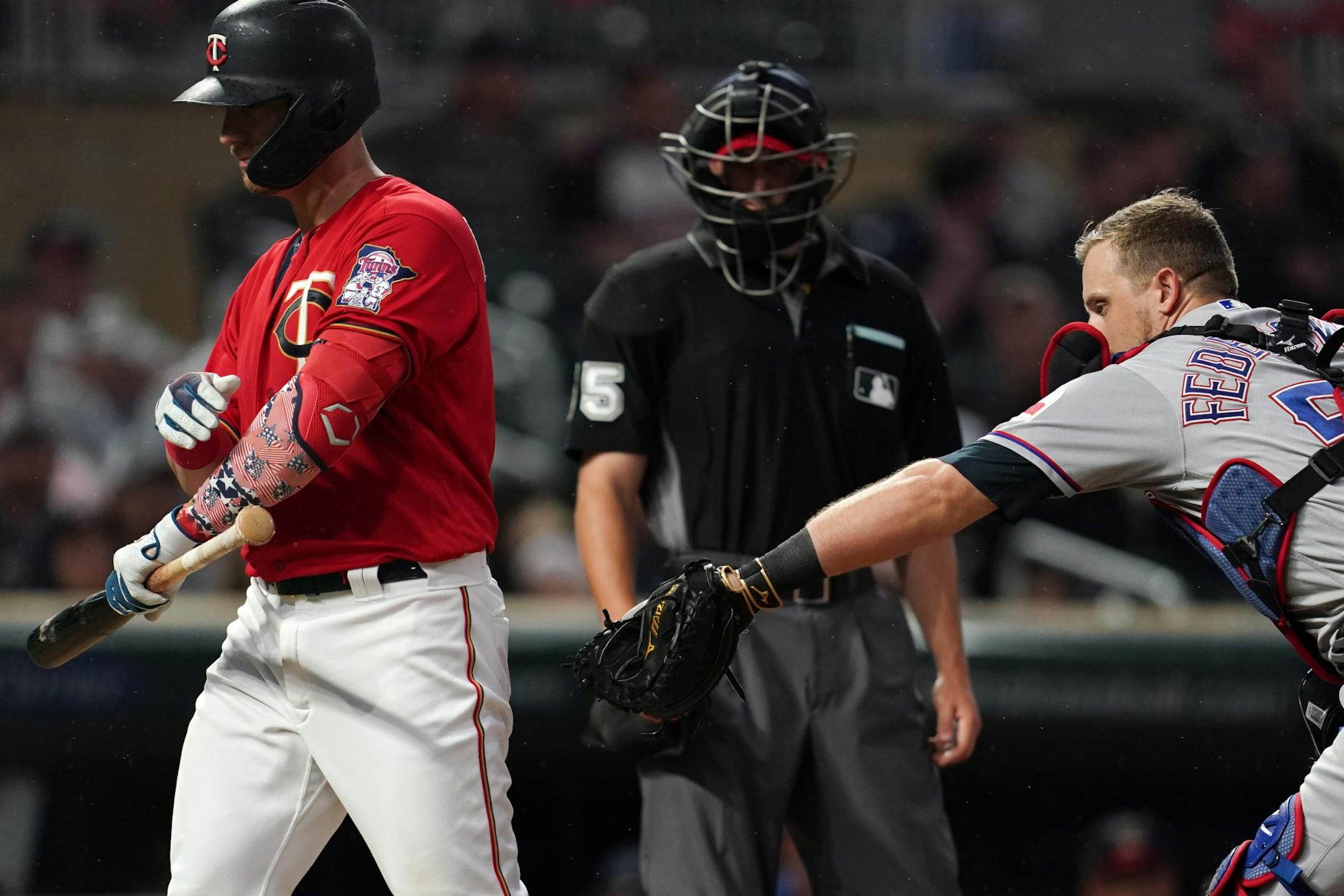 Texas Rangers catcher Tim Federowicz (50) reached back to tag out Minnesota Twins catcher Mitch Garver (18) as he walked back to the dugout after striking out in the fourth inning.