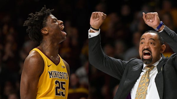 Michigan coach Juwan Howard, right, had generous praise for the Gophers' Daniel Oturu, right, after the sophomore center's 30-point, seven-rebound gam