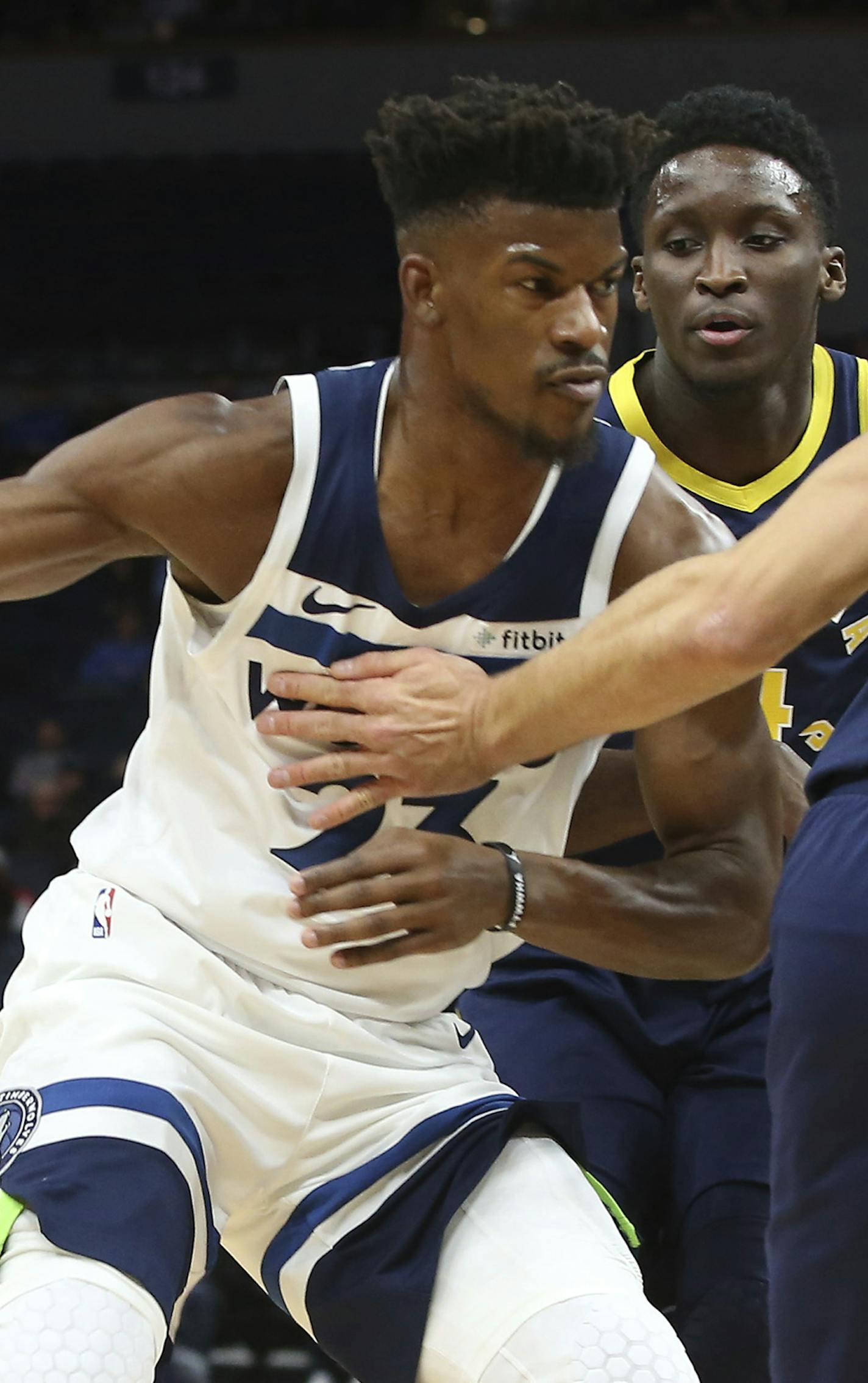 Minnesota Timberwolves' Jimmy Butler, left, tries to work between Indiana Pacers' Victor Oladipo, center, and Bojan Bogdanovic, of Croatia, in the first half of an NBA basketball game Monday, Oct. 22, 2018, in Minneapolis. (AP Photo/Jim Mone)