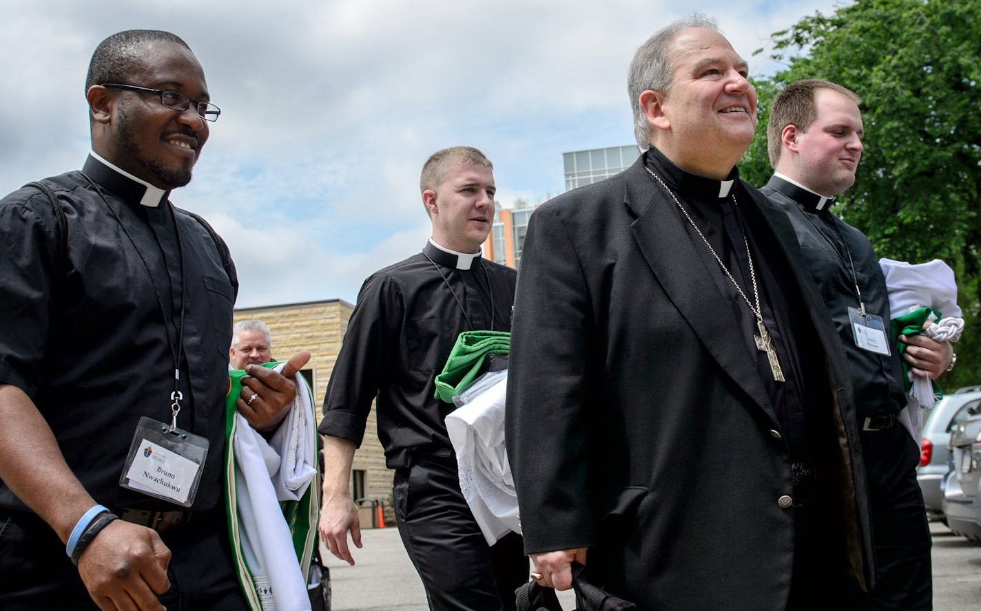 Archbishop Bernard Hebda, Apostolic Administrator of the Archdiocese of Saint Paul and Minneapolis, center, walked with a group of deacons out of Saint John The Evangelist Catholic Church for a Mass of priests only. ] GLEN STUBBE * gstubbe@startribune.com Wednesday, June 17, 2015 ORG XMIT: MIN1506171338050905