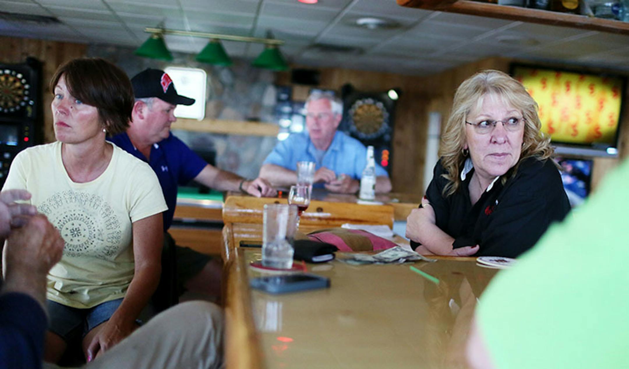 Harbor Inn Garrison Creek bartender Cheryl Garvin, right, and patron Pam Boyd, left, chat with other patrons following a Twin Cities TV news story that reported on Lake Mille Lacs and a potential early season hook and line walleye closing Wednesday, July 29, 2015, on Lake Mille Lacs.