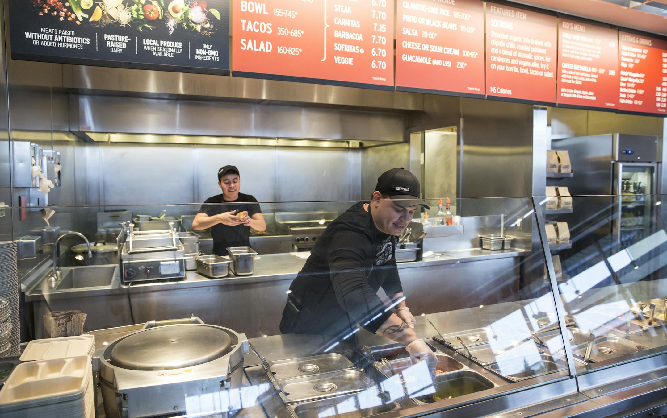 FILE - In this Tuesday Dec. 15, 2015, file photo, a Chipotle Mexican Grill employee prepares food in Seattle. Chipotle Mexican Grill Inc. reports quarterly financial results, Tuesday, Feb. 6, 2018. (AP Photo/Stephen Brashear, File)