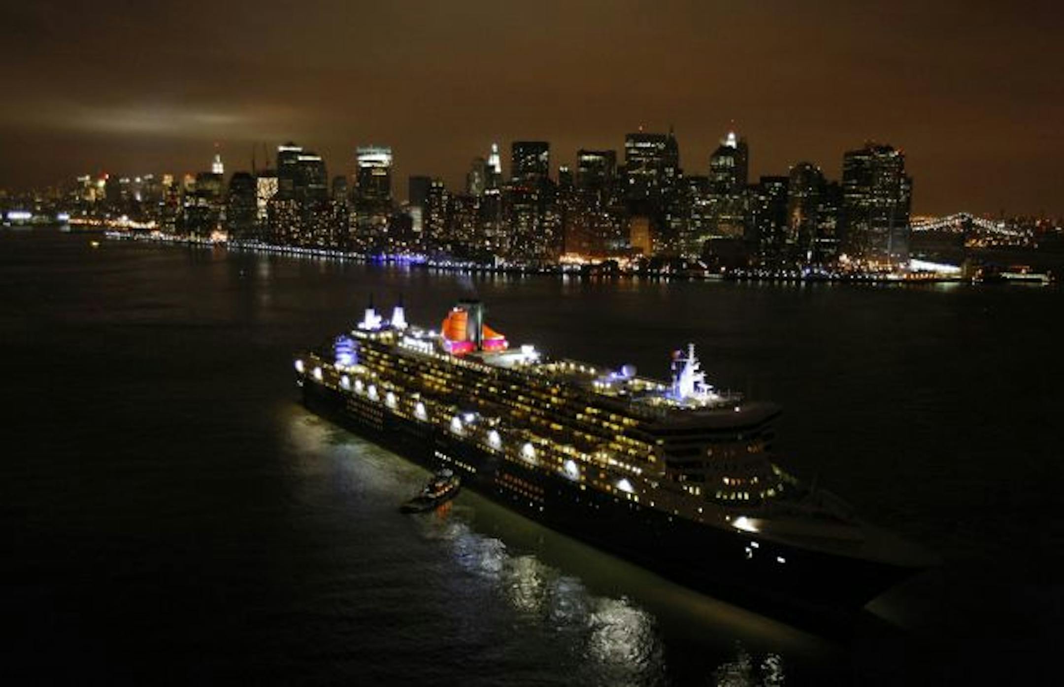 The Queen Mary 2 sits in New York Harbor at the tip of Manhattan waiting to rendezvous with her sister ships, the Queen Victoria and the Queen Elizabeth 2 Sunday, Jan. 13, 2008 in New York. This is the only time the three Queen ships will ever meet.