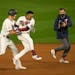 Minnesota Twins center fielder Max Kepler (26) chased down designated hitter Jorge Polanco (11) to celebrate after Polanco hit the ninth inning walk o
