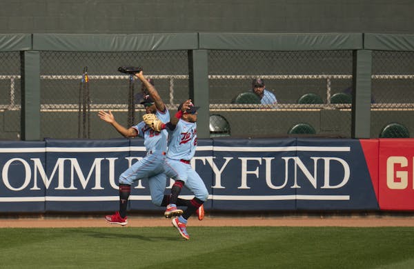Minnesota Twins left fielder Eddie Rosario's (20) left hand hit teammate Minnesota Twins center fielder Byron Buxton (25) as they were both vying for 