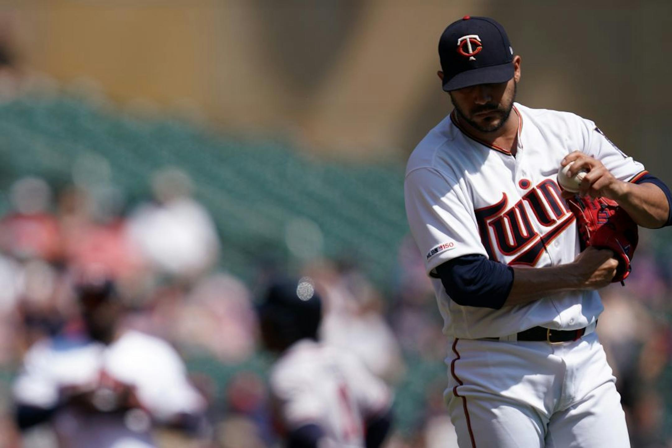 Minnesota Twins starting pitcher Martin Perez (33) stood on the mound as Atlanta Braves second baseman Ozzie Albies (1) rounded third after hitting a solo home run in the first inning.