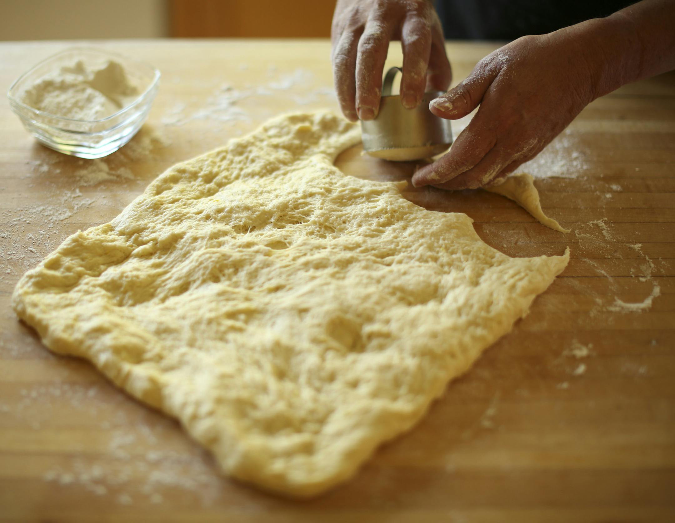 Baking Central takes on krofi, the light and lemony fried pastry from Slovenia. Krofi preparation in Kim Ode's Edina kitchen on Thursday afternoon, October 10, 2013. Using a cutter to cut the krofi from the stretched dough. ] JEFF WHEELER ‚Ä¢ jeff.wheeler@startribune.com