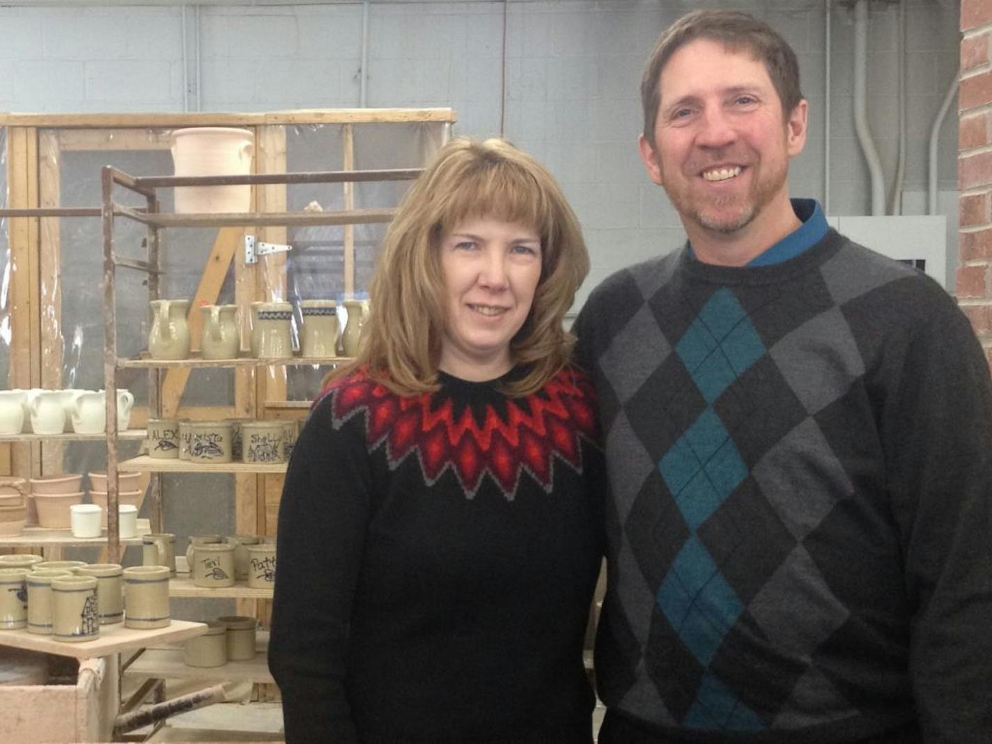 The new owners of Red Wing Pottery, Bruce and Irene Johnson, pose for a photo on Friday, Dec. 27, 2013, in Red Wing, Minn. The couple bought the iconic stoneware company from third-generation owner Scott Gillmer. The couple also recently bought Red Wing Stoneware.