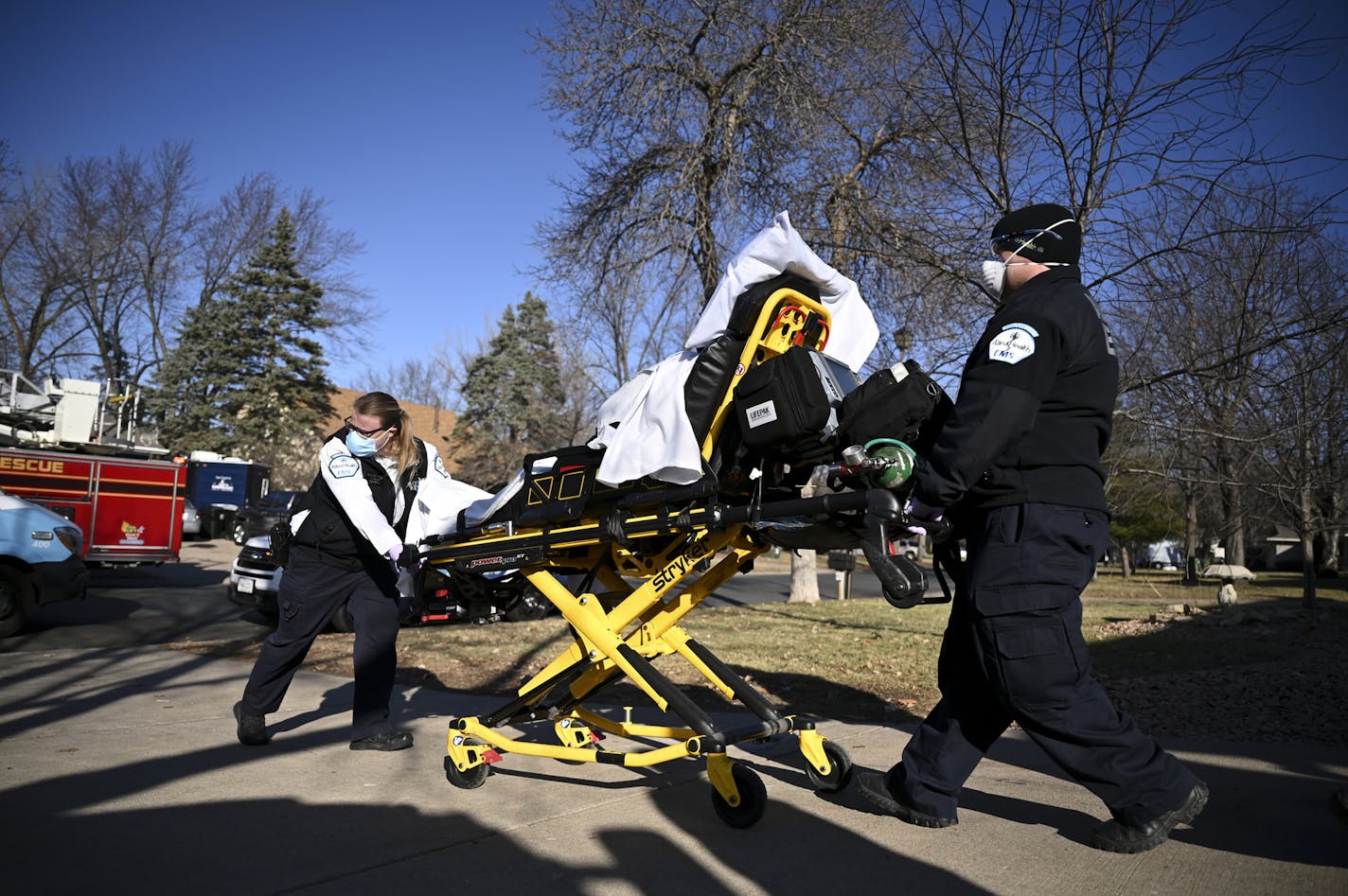 Allina Health paramedics Kelsey Cook and Dan Lennartson pushed a patient on a gurney out to their ambulance Wednesday afternoon while responding to a call in Coon Rapids.