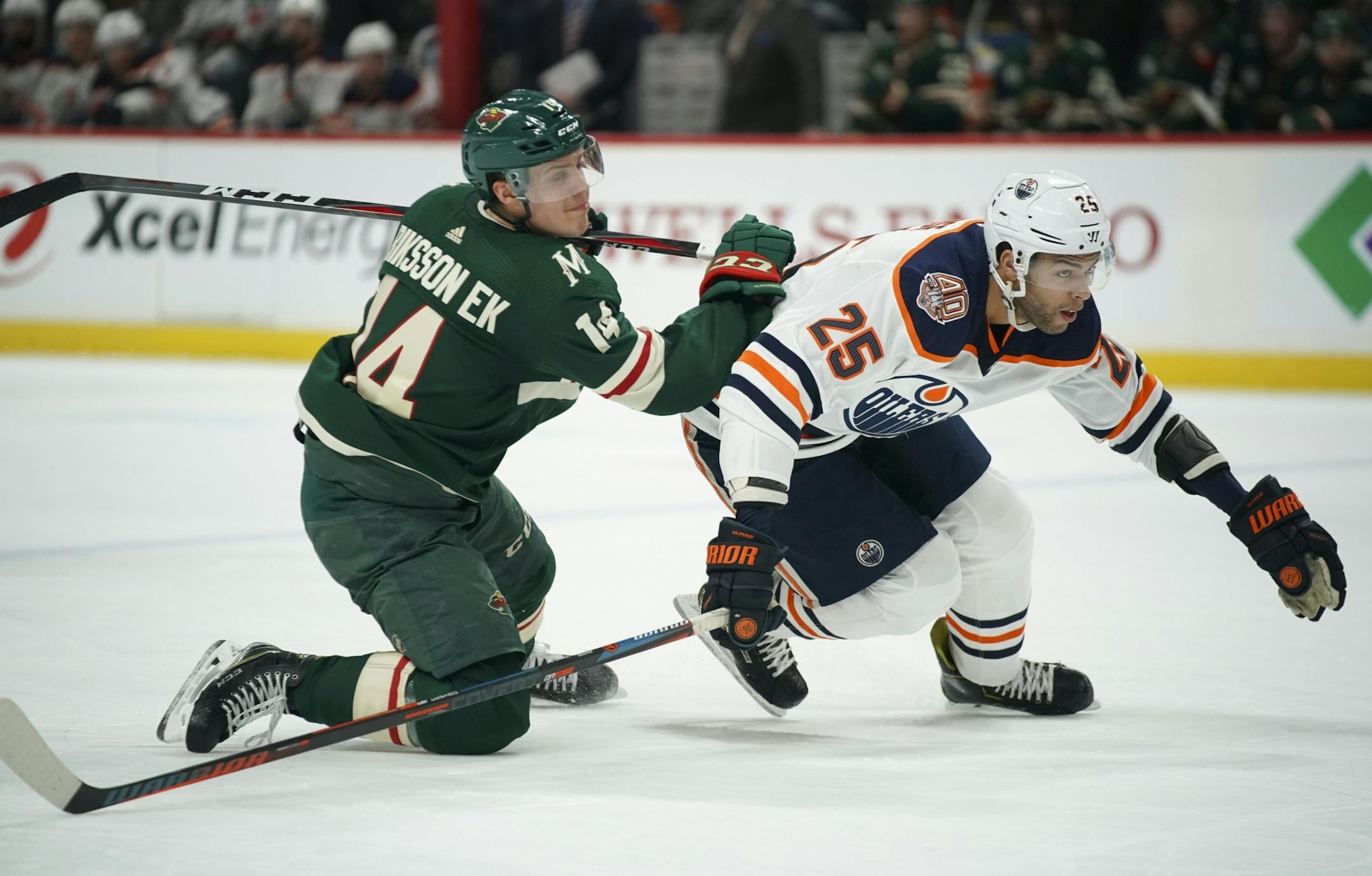 The Wild's Joel Eriksson Ek and Edmonton Oilers defenseman Darnell Nurse (25) were low to the ice in the second period.