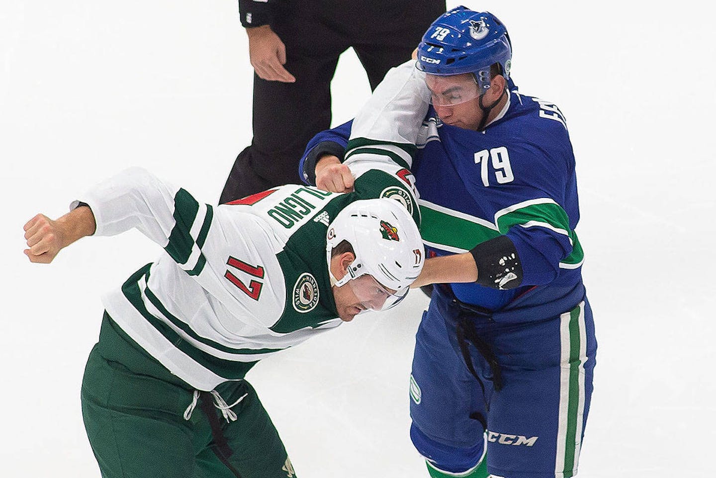 Before the spearing incident in Sunday's game, Vancouver's Micheal Ferland (79) fights Minnesota's Marcus Foligno (17) during the first period.