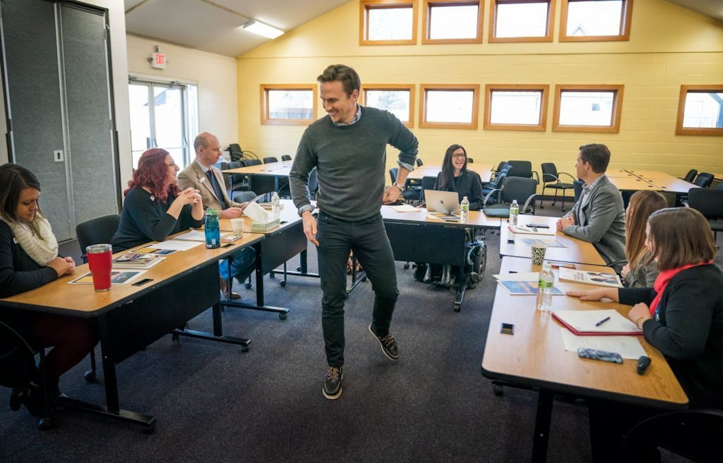 Constellation Fund CEO Andrew Dayton handed out information on Monday during a site visit to the YMCA to discuss the organization's youth intervention services.