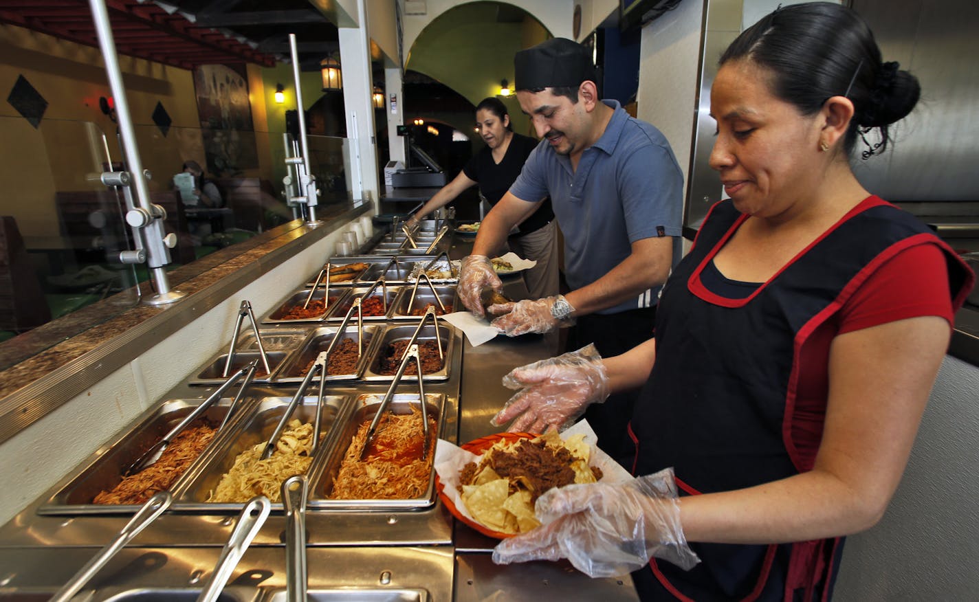 Isela Perez Pacheco, co-owner, Victor Martinez Sordovel, co-owner, and Aurelie Ponce Valdez, server, serving up food at Maya. ] Diners and Cafes along Central Ave. in NE Minneapolis. (MARLIN LEVISON/STARTRIBUNE(mlevison@startribune.com)