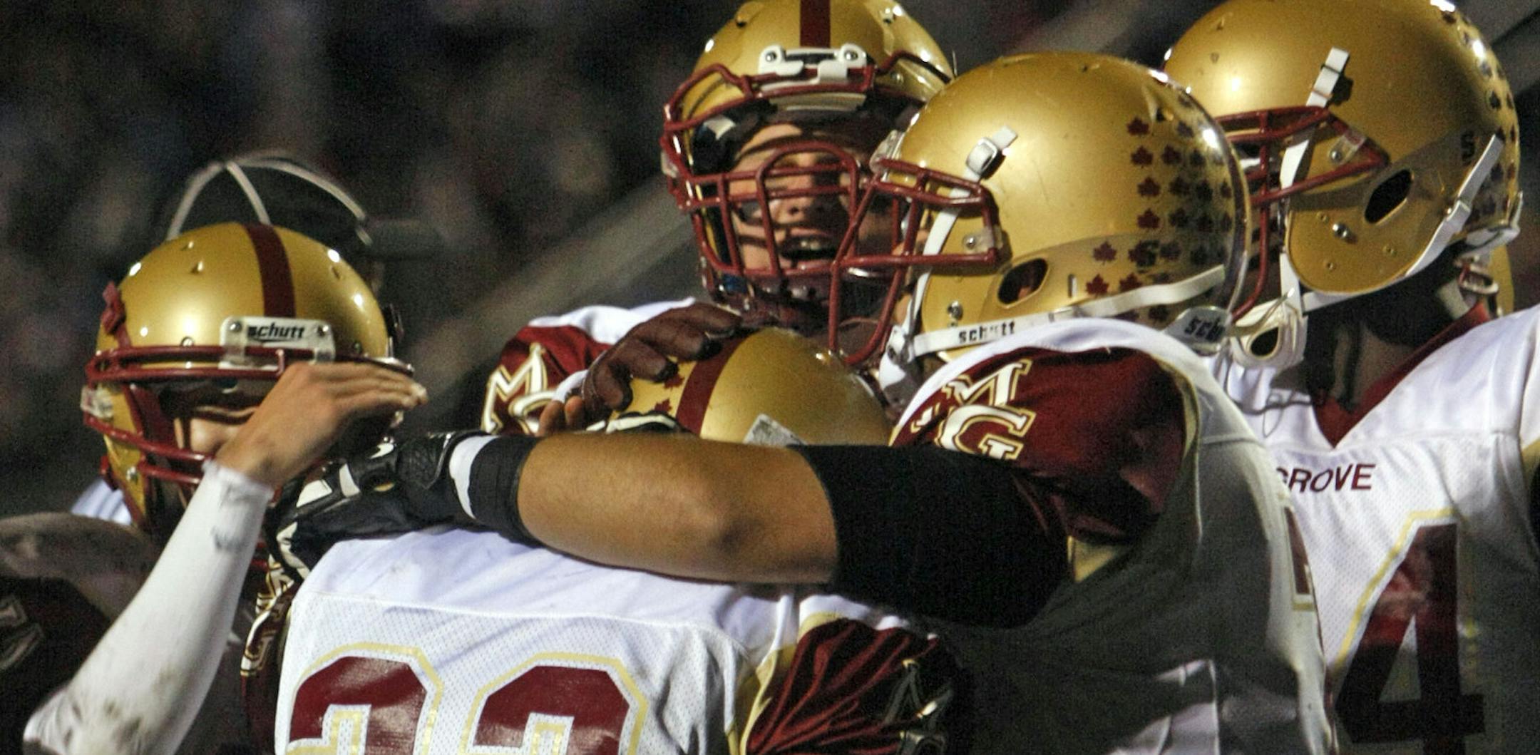 Maple Grove teammates congratulate running back Clark Wieneke after scoring a touchdown at Blaine High School on Friday night. ] Chris Kelleher, Special to the Star Tribune, 9/20/2013, Blaine, MN.