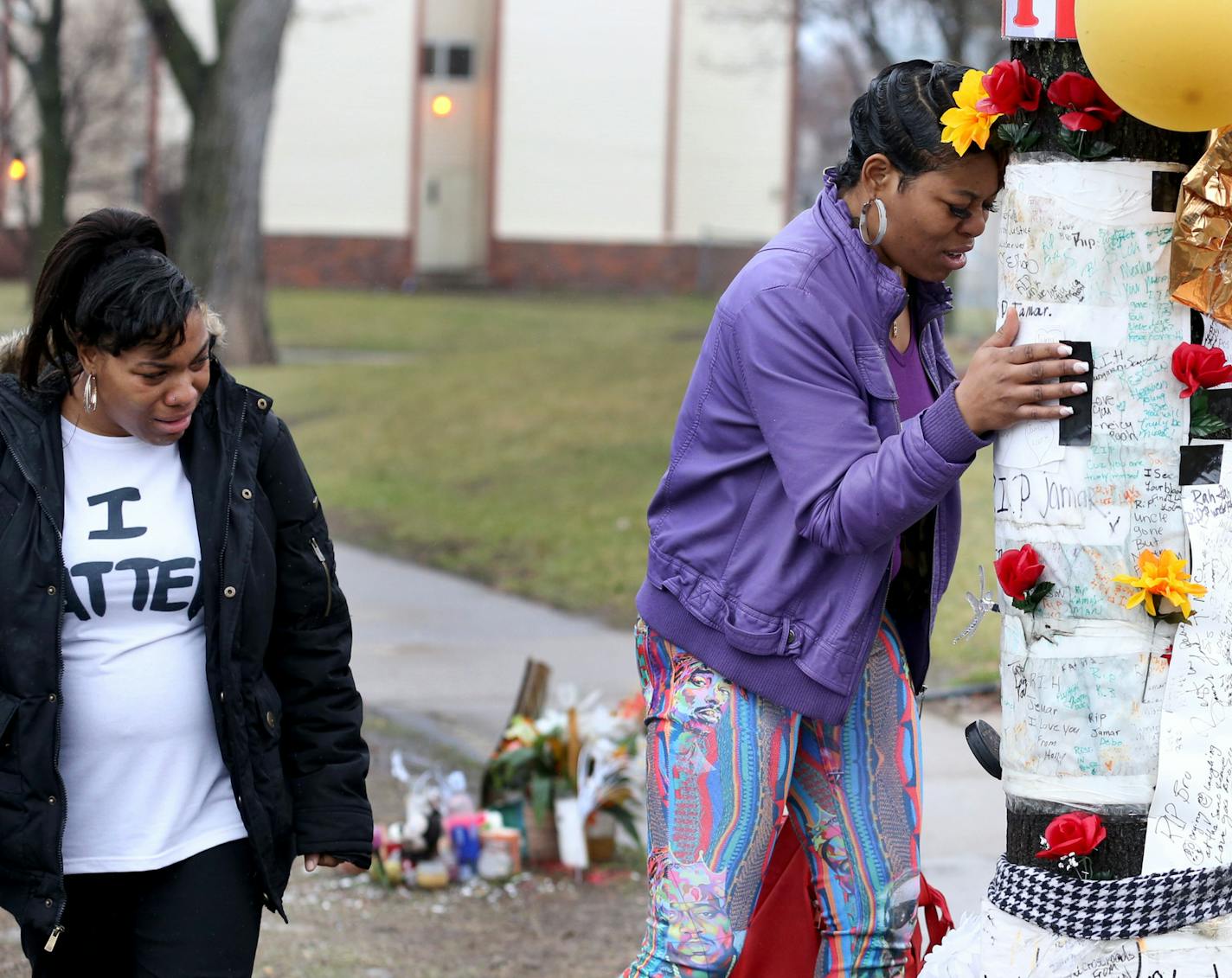 Emma Burns, who said she is a sister of Jamar Clark, visited the memorial site for Clark Wednesday, March 30, 2016, shortly after Hennepin County DA Mike Freeman announced there would be no charges against the police officers who shot Clark in November.]STARTRIBUNE)djoles@startribune.com With a decision on charging of Minneapolis police officers in the shooting of Jamar Clark, rain falls on the memorial to Clark as an emergency vehicle passes along Plymouth Ave. N. Wednesday, March 30, 2016, in