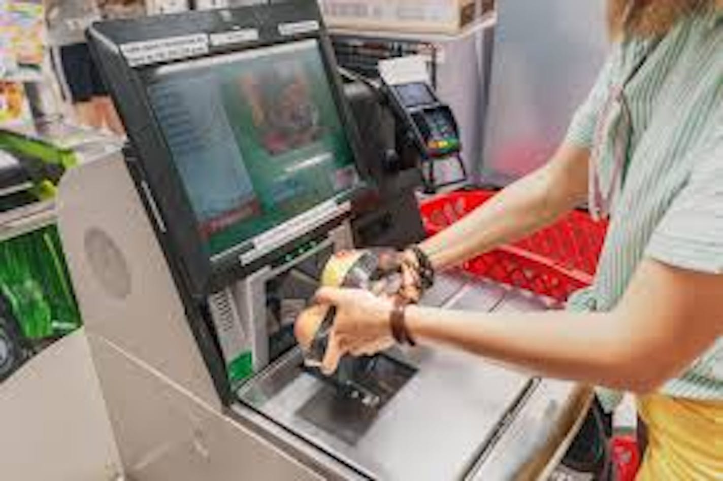 A grocery store customer using selfcheckout.