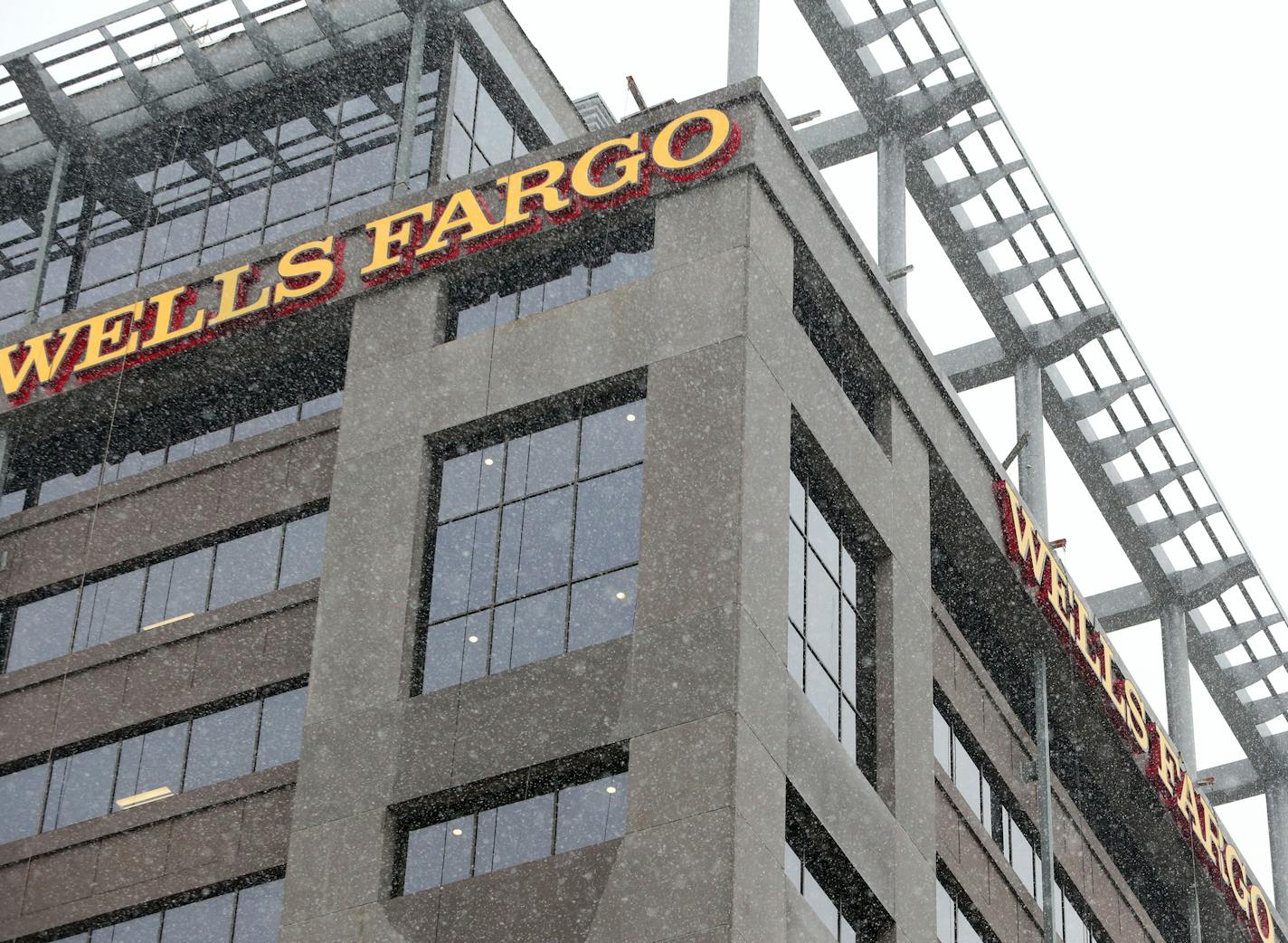 The U.S. Bank Stadium with the signage from the Wells Fargo towers to the north, seen from 11th Ave. S Wednesday, Dec. 23, 2015, in Minneapolis, MN.](DAVID JOLES/STARTRIBUNE)djoles@startribune.com Minnesota Vikings sue Wells Fargo saying the bank is putting up signs on its towers that are so big they will essentially "photo bomb" network shots during NFL games. Vikings seeking an emergency declaratory judgment to stop Wells Fargo.