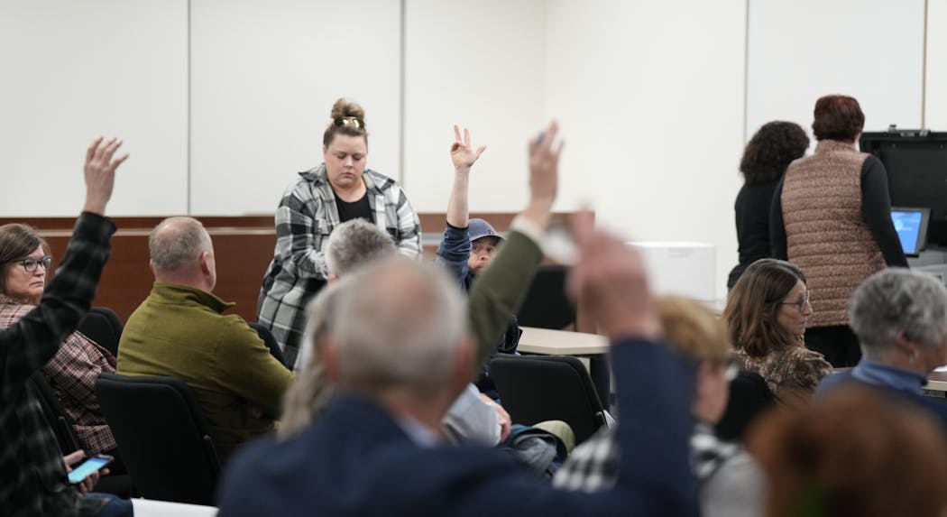 During a voting machine accuracy test in Faribault, Minn., on Feb. 13, Drew Roach, center, frustrated that the public could not ask questions, turned to the crowd to ask those who wanted answers to raise their hands.