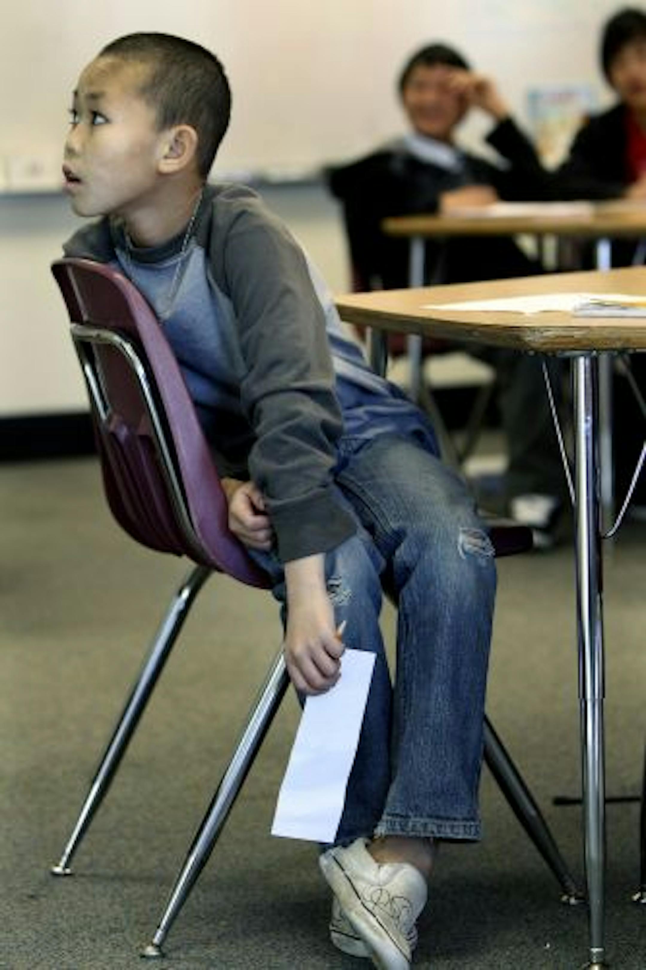 Way Ley Paw watched his teacher for instructions on how to complete a writing project in his English Language Learners (ELL) class at Washington Technology Magnet School.