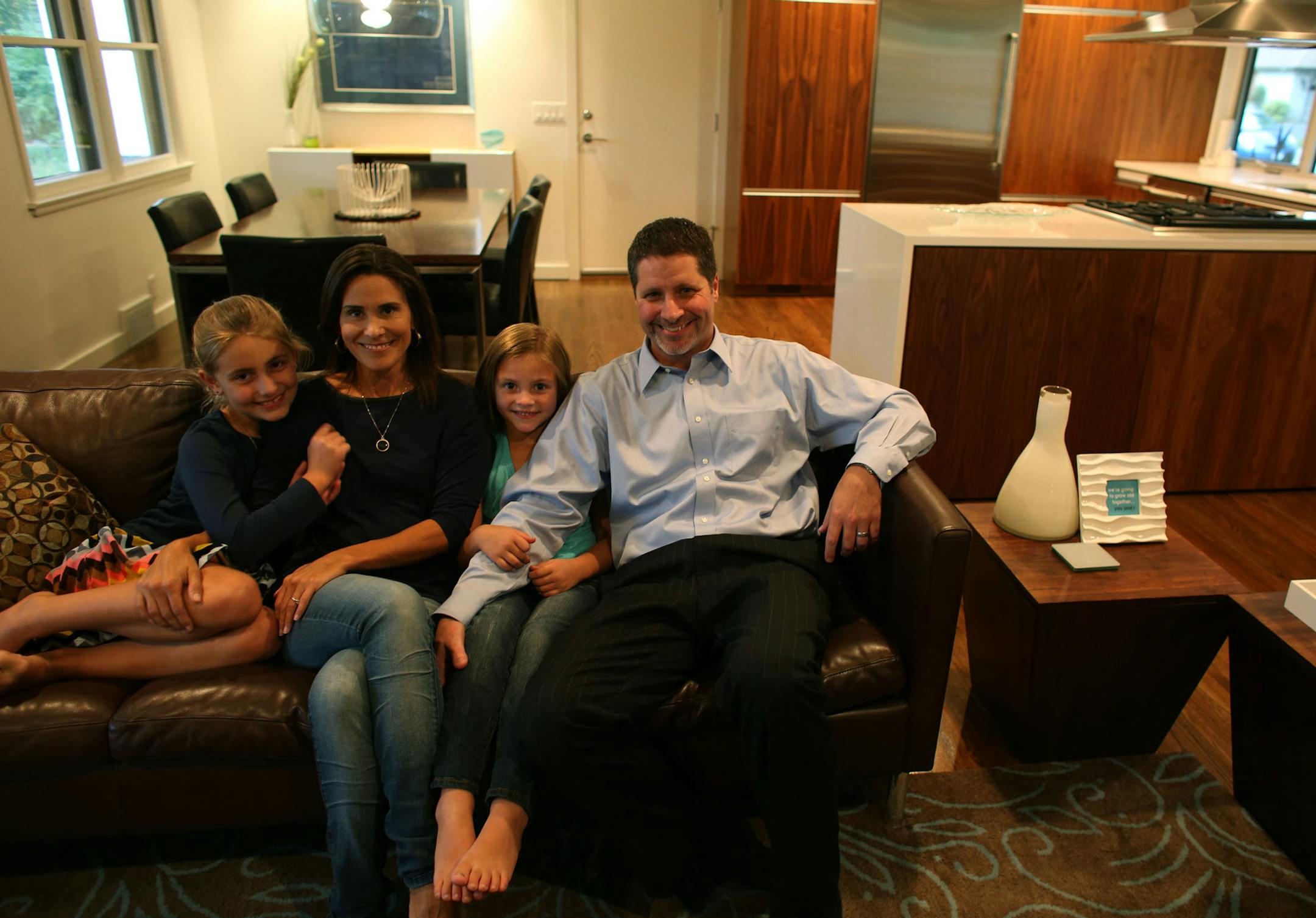The Emersons, Joely, 8, mom, Audra, Lila, 7, and Todd satin their living room in their remodeled home in Edina, Min., Thursday, October 17, 2013. ] (KYNDELL HARKNESS/STAR TRIBUNE) kyndell.harkness@startribune.com