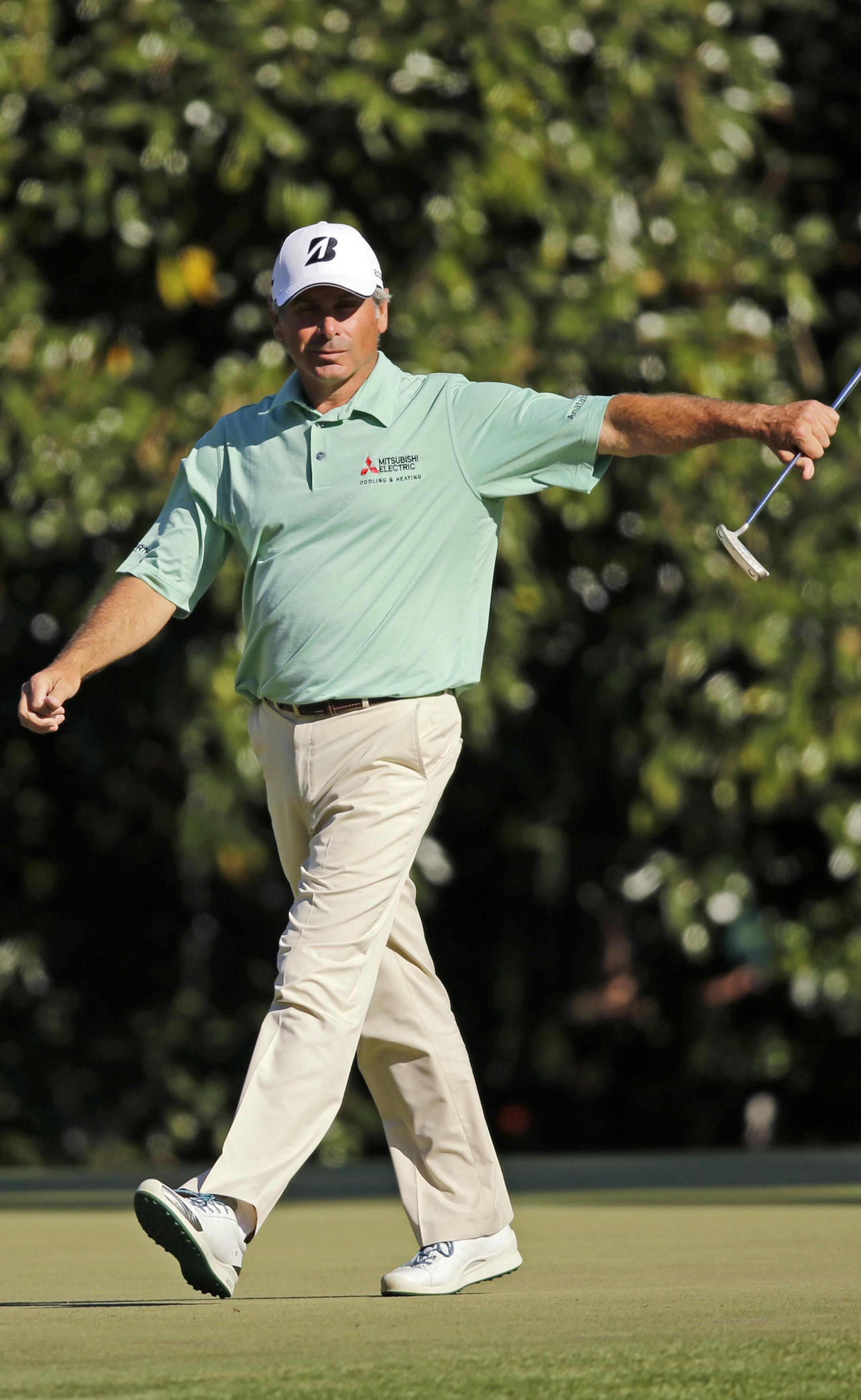 Fred Couples walks off the 11th green after putting out during the third round of the Masters golf tournament Saturday, April 13, 2013, in Augusta, Ga. (AP Photo/Matt Slocum)