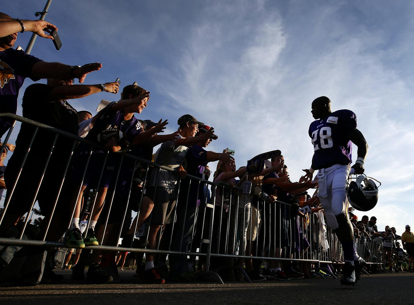 Minnesota Vikings running back Adrian Peterson (28) was greeted by fans before practice last August.