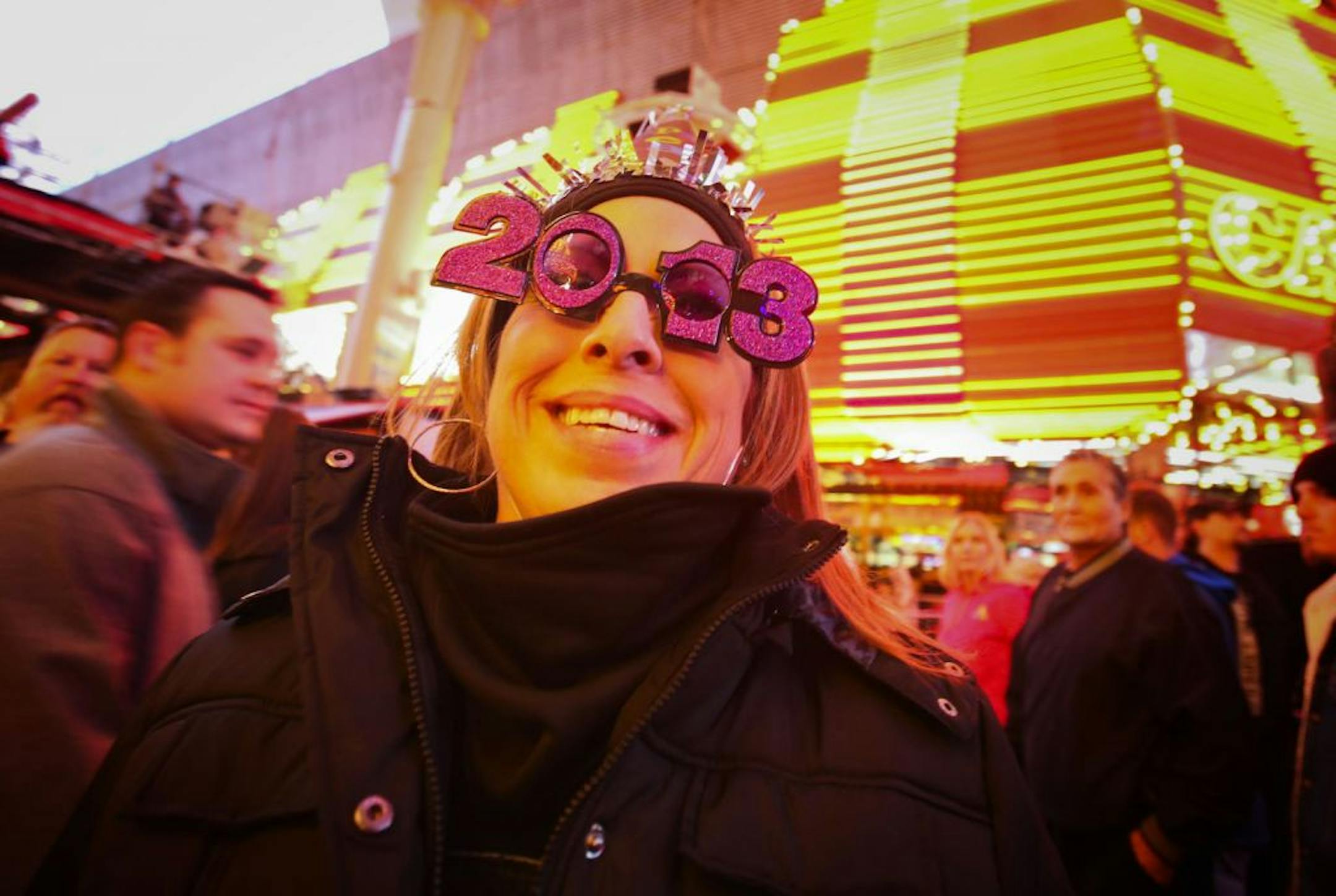 Carmen Zepeda of Corpus Christi, Texas show off her 2013 New Year's Eve glasses at the Fremont Street Experience Downtown Countdown in Las Vegas on Monday, Dec. 31, 2012.