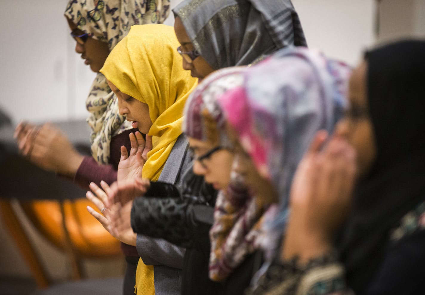 Fardosa Hassan, in yellow, the Muslim student advisor with Campus Ministry at Augsburg College, attends student-led Friday prayer at Augsburg College in Minneapolis on Friday, February 19, 2016. ] (Leila Navidi/Star Tribune) leila.navidi@startribune.com