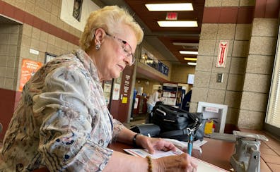 Karen Schaar, 76 of Bemidji, takes Mother's Day cards for her daughters to the Bemidji post office Wednesday. For years, she has paid extra for priori