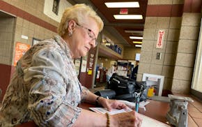 Karen Schaar, 76, of Bemidji, takes Mother's Day cards for her daughters to the Bemidji post office Wednesday. For years, she has paid extra for prior