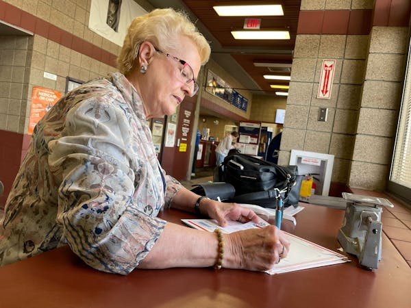 Karen Schaar, 76 of Bemidji, delivers Mother's Day cards for her daughters to the Bemidji Post Office on Wednesday. For years now, she pays extra to s