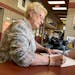 Karen Schaar, 76 of Bemidji, takes Mother's Day cards for her daughters to the Bemidji post office Wednesday. For years, she has paid extra for priori