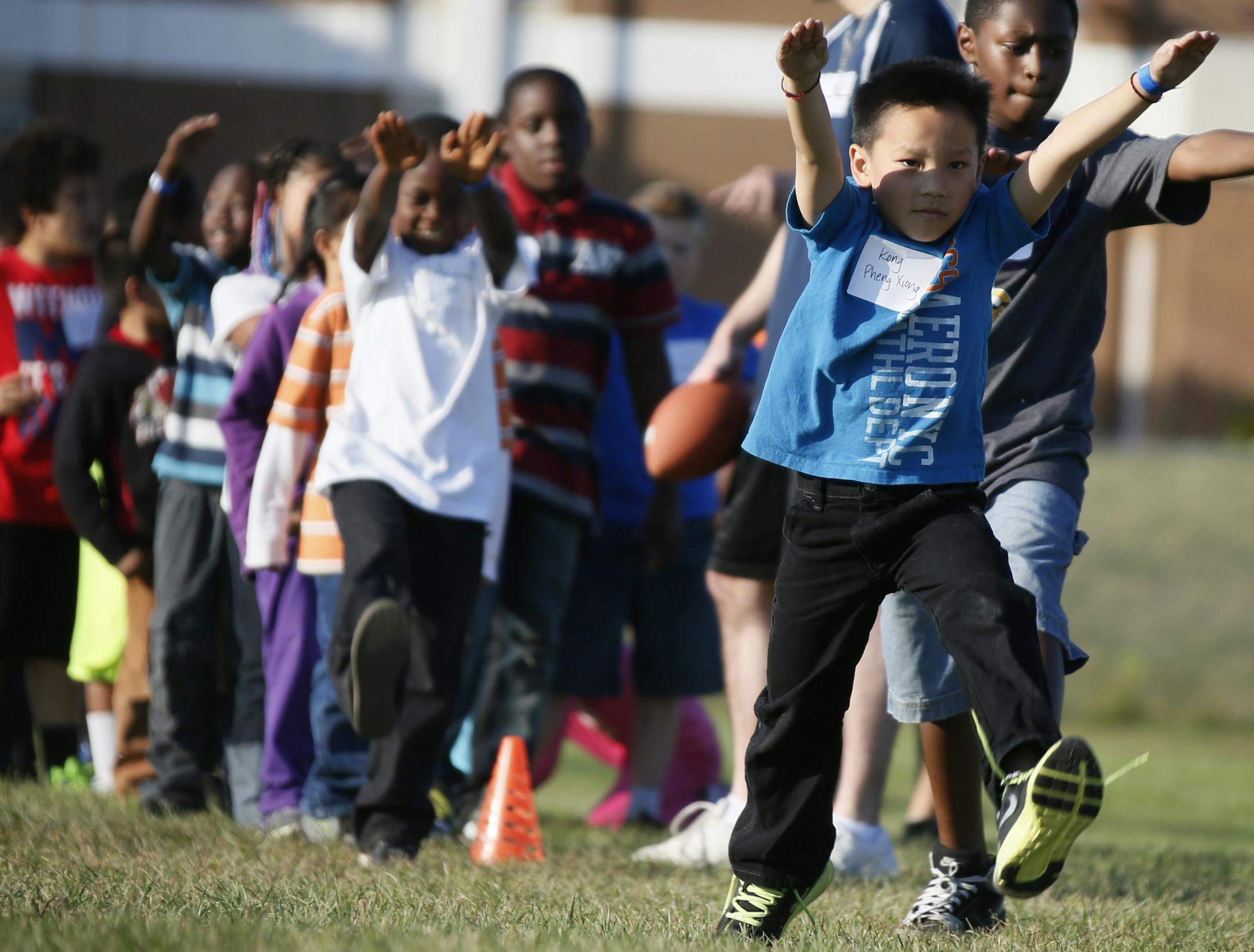 Kong Pheng Xiong warmed up at the camp lead by EJ Henderson and his team from Youth Pro Fitness and Nutrition (YoPro) are coming to Brooklyn Park to teach the city kids nutritional tips. The Brooklyn Park Police Departments Police Athletic League, the former MN Vikings linebacker and the YoPro trainers are teaming up to give kids between the ages of 7 and 13 the chance to experience and learn more about speed and agility, coordination, flexibility and living a healthy lifestyle through nutrition