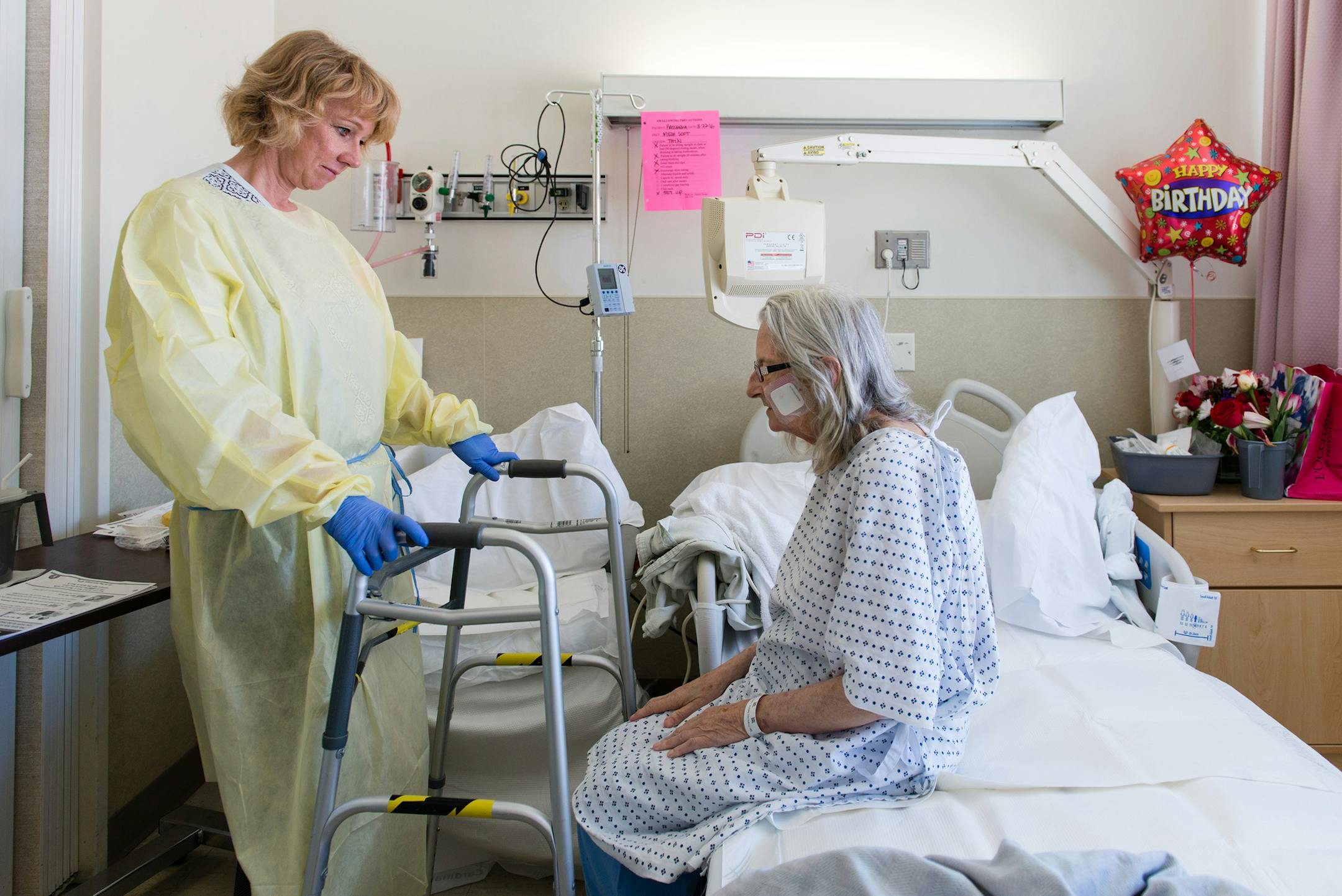 Nurse specialist Annelie Nilsson checks on patient Janet Prochazka, 74, during her stay at the San Francisco General Hospital on Thursday, March 24, 2016. (Heidi de Marco/KHN)