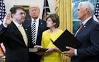 President Donald Trump watches as Vice President Mike Pence swears in Robert Wilkie as the new secretary of the Department of Veterans Affairs in the 