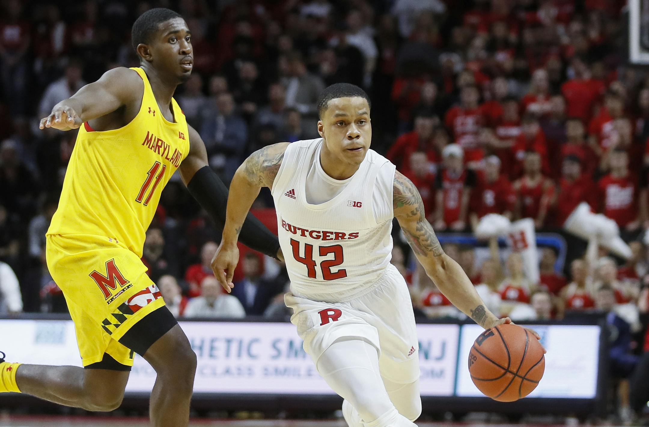 Rutgers' Jacob Young (42) drives past Maryland's Darryl Morsell (11) during the second half of an NCAA college basketball game Tuesday, March 3, 2020, in Piscataway, N.J. (AP Photo/John Minchillo)