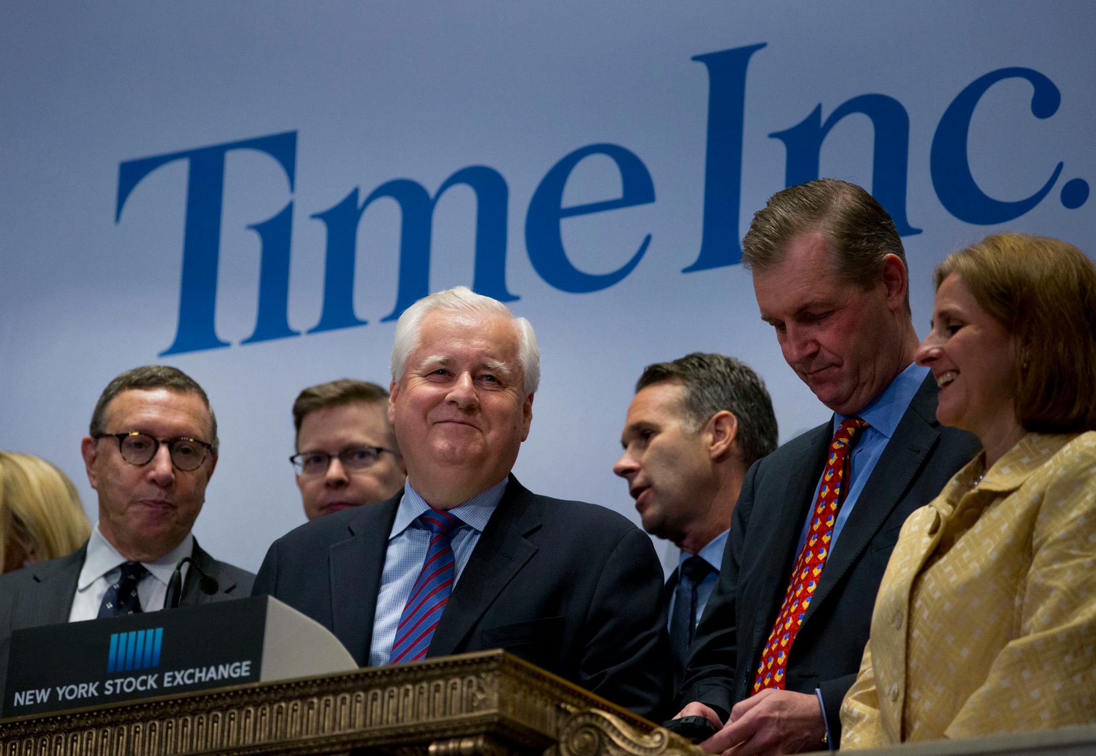 Joseph Ripp, chief executive officer of Time Inc., center, Norman Pearlstine, executive vice president and chief content officer of Time Inc., left, and Jeff Bairstow, executive vice president and chief financial officer of Time Inc., second right, prepare to ring the opening bell on the floor of the New York Stock Exchange (NYSE) in New York, U.S., on Monday, June 9, 2014. Time Inc. shares fell in their first day of trading after a spinoff from Time Warner Inc., reflecting the challenges of bei