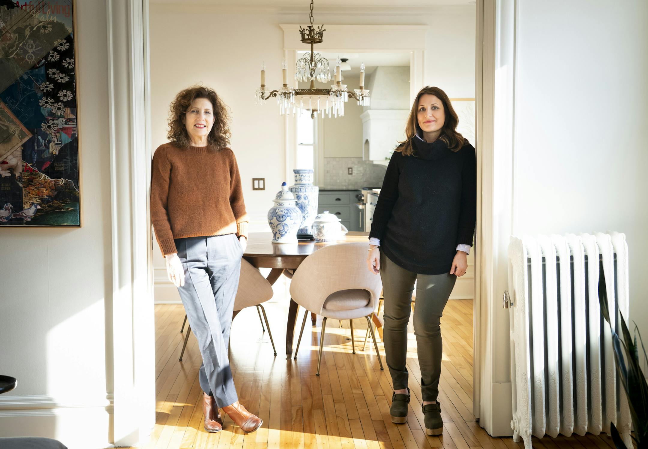 Pamela Diamond and her daughter Kathryn Rozin in the entry to Rozin's dining room in Minneapolis. The two women and their families share a duplex; Diamond's dining room a floor below has the same layout.